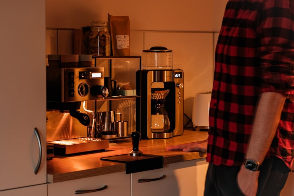 Home coffee brewing setup with a grinder and coffee maker on a kitchen counter