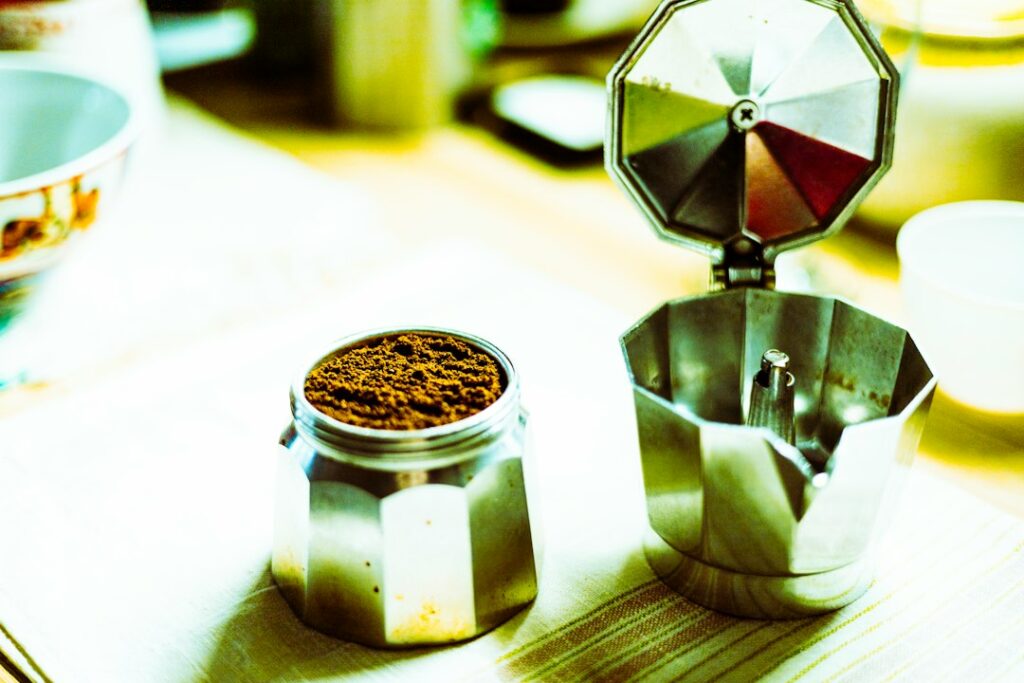 Fresh coffee grounds in a moka pot on a home kitchen work surface